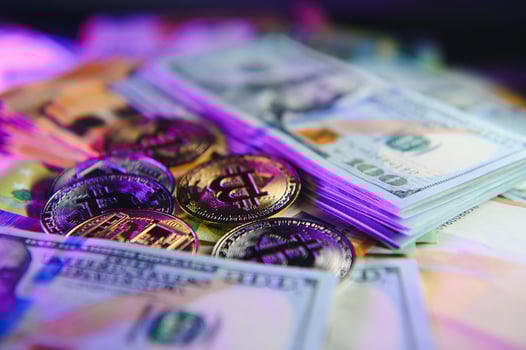 Close up heap of golden bitcoin physical coins on top of Euro, dollar banknotes background, high angle view, selective focus photo
