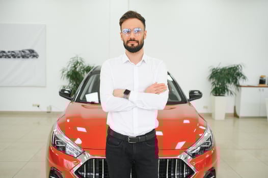 a man examines a car in a car dealership photo