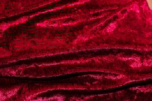 Texture of red velor corduroy fabric with folds photo