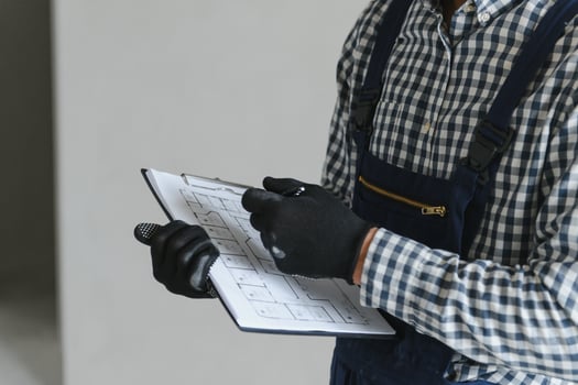 A dedicated worker doing calculations for material for apartment in construction process. photo