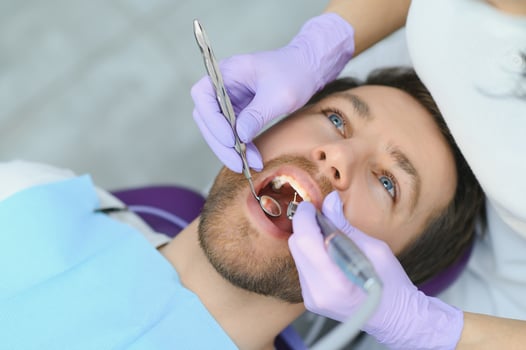 Man having teeth examined at dentists photo