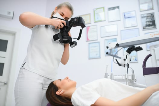 dentist clinic. A female dentist photographing her client's teeth during an appointment at the dental clinic. photo