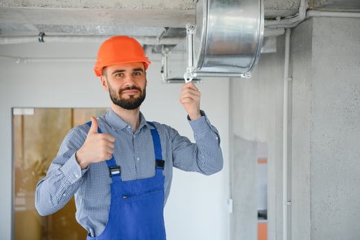 hvac engineer install heat recovery ventilation system for new house. copy space photo