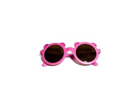 isolated image of pink child glasses. shot from the top photo
