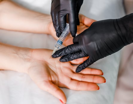Injections into women's palms in a modern beauty salon. The concept of health care and self-care photo