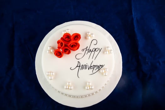 Happy anniversary White Pearl Cake or women day and valentine celebration with flowers, spoon and fork served on board isolated on napkin side view of cafe bake food photo