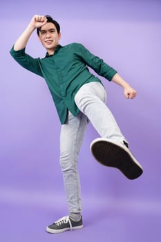 Young Asian businessman on purple background photo