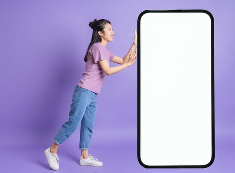 Photo of young Asian girl on purple background