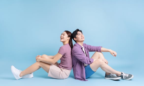 Young Asian couple on blue background photo