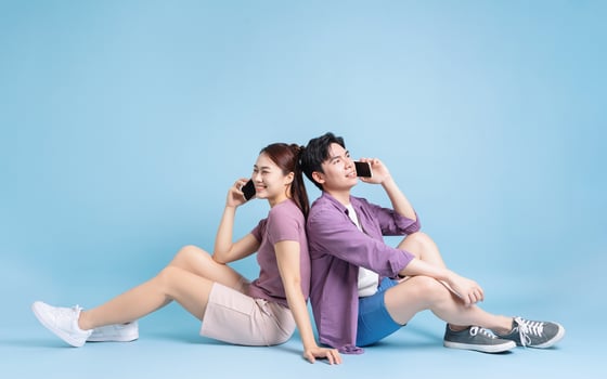 Young Asian couple on blue background photo