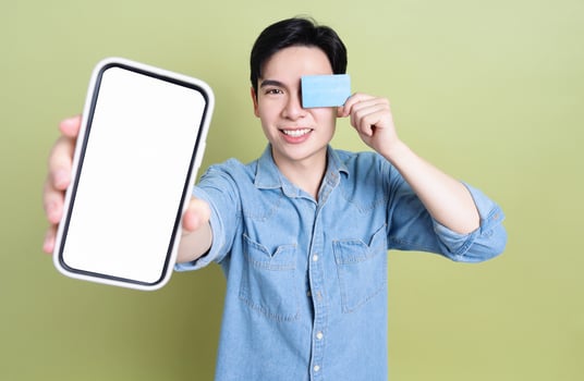 Photo of young Asian man on green background