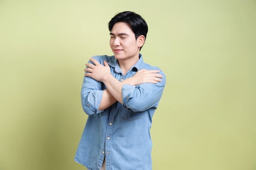 Photo of young Asian man on green background