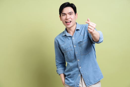 Photo of young Asian man on green background