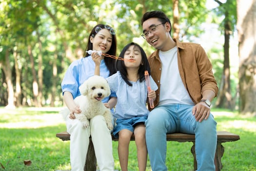 Photo of young Asian family at park