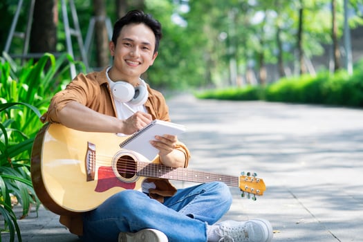 Portrait of young Asian man outside photo