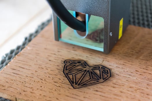 Engraving and cutting laser, example of a heart on a wooden support photo