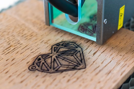 Engraving and cutting laser, example of a heart on a wooden support photo