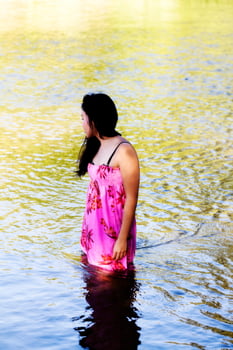 Japanese American Woman Standing In River Wearing Dress photo