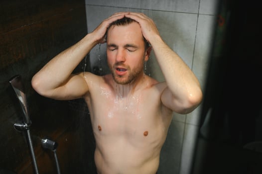 relaxing time.fresh shower concept.under good looking man is under water drops photo