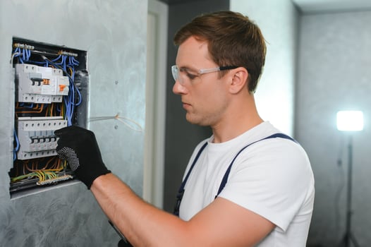 Electrician worker at work on an electrical panel photo