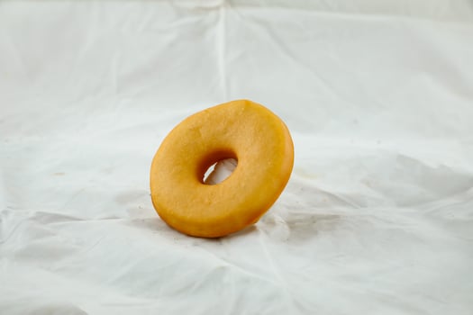 Plain donut isolated on grey background side view of baked food breakfast on table photo