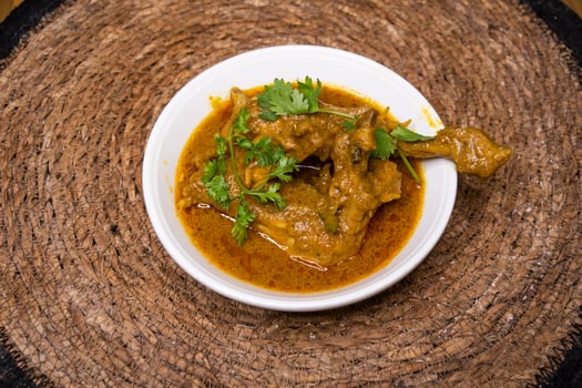 Chicken Rezala korma karahi served in dish isolated on wooden background top view indian spices, bangladeshi and pakistani food photo