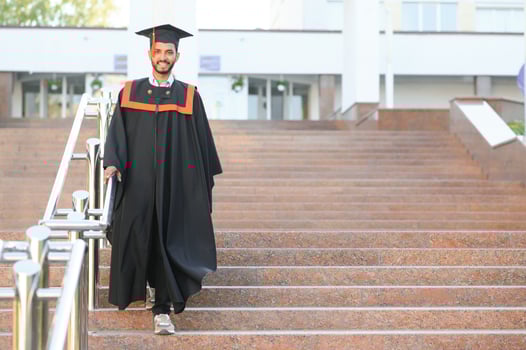 Young indian graduated boy holding his graduation degree convocation ceremony. student graduate posing. photo