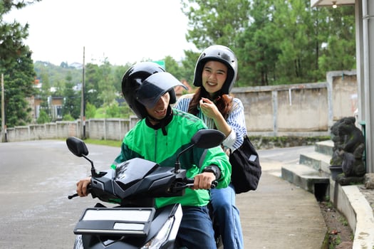 Asian Online Driver and His Female Passenger Smiling photo