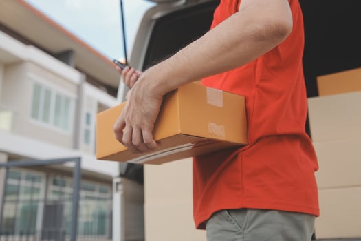 Asian delivery express courier young man use giving boxes to woman customer he wearing protective face mask at front home photo