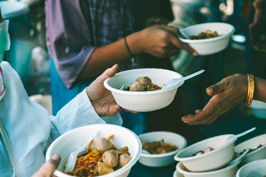 Hungry homeless people request free food donations from volunteers social concept of helping photo