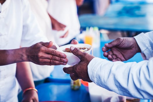 Hungry homeless people request free food donations from volunteers social concept of helping photo