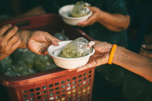 Volunteers serving hot meals to hungry migrants humanitarian aid concept. photo