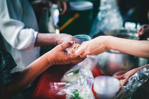 Volunteers offer free food to the poor. the concept of food sharing. photo
