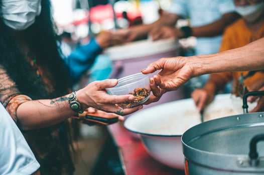 Feeding concept Homeless people offer free food from outdoor volunteers. photo