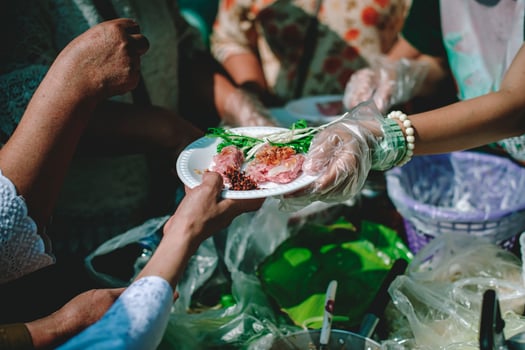 Volunteers offer free food to the poor. the concept of food sharing. photo