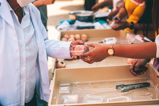 Volunteers offer free food to the poor. the concept of food sharing. photo