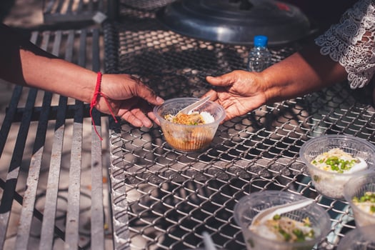 Volunteers are helping to give free food to the hungry homeless. food service and food donation concept photo