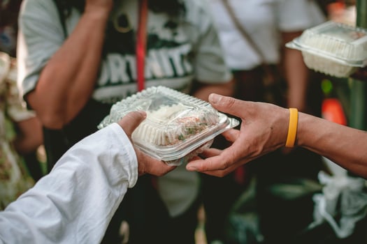 Volunteers are helping to give free food to the hungry homeless. food service and food donation concept photo