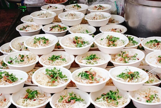 Food noodles are in stacked paper cups for free food distribution. photo