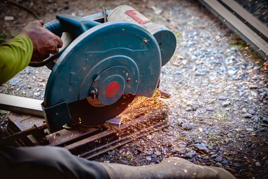 The industrial use of a metal cutting saw involves heat and sparks from skilled technicians. photo