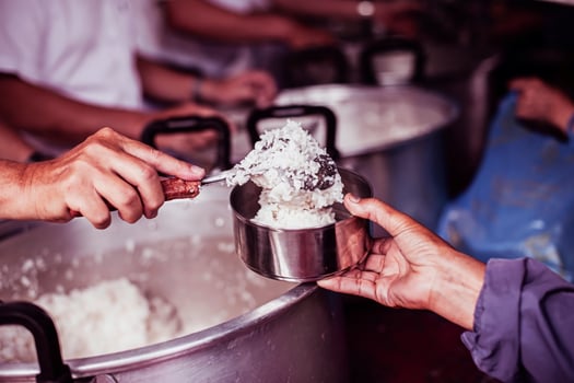 Feeding the poor to hands of a beggar. Poverty concept photo