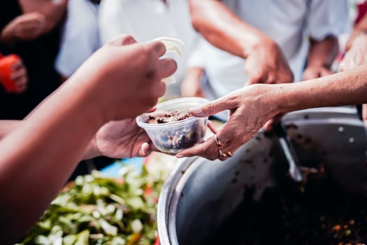 Giving free food to the poor by humane people photo