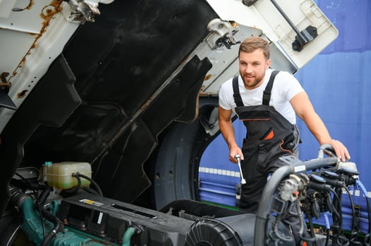 Mechanic repairing the truck in service. photo