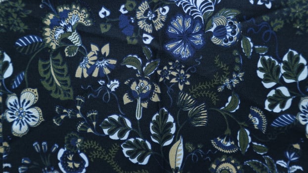 Fragment of colorful retro tapestry textile pattern with floral ornament useful as background photo