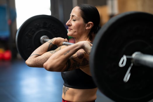 Sportive strong woman doing an effort to lift weights photo