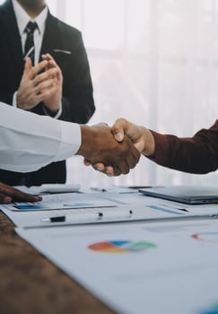 Real estate agent and customers shaking hands together celebrating finished contract after about home insurance and investment loan, handshake and successful deal. photo