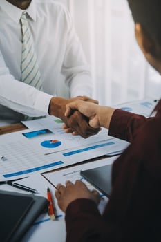 Real estate agent and customers shaking hands together celebrating finished contract after about home insurance and investment loan, handshake and successful deal. photo