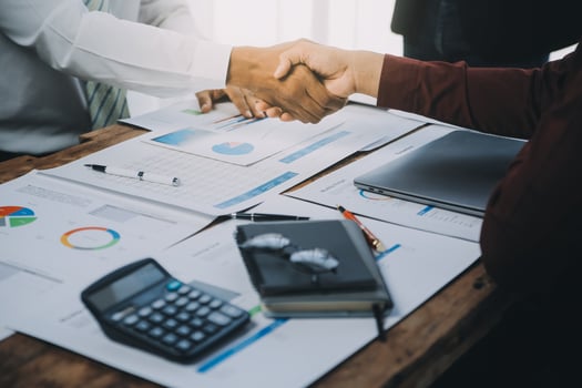 Real estate agent and customers shaking hands together celebrating finished contract after about home insurance and investment loan, handshake and successful deal. photo