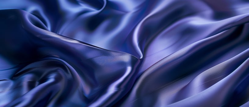 Rippling azure blue satin draped in fluid waves, the light playing across the lustrous folds of the vibrant fabric. photo