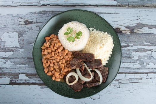 Brazilian food dish with beans, rice and meat photo